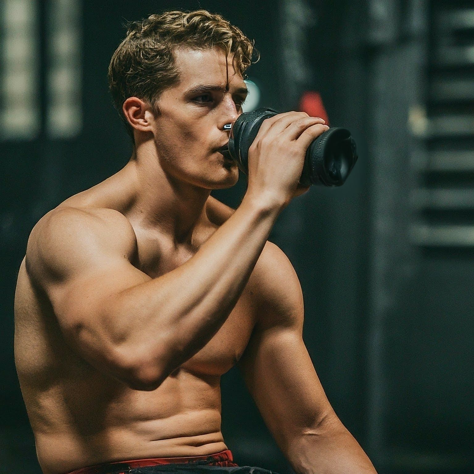 a man is drinking water to stay hydrated during workout