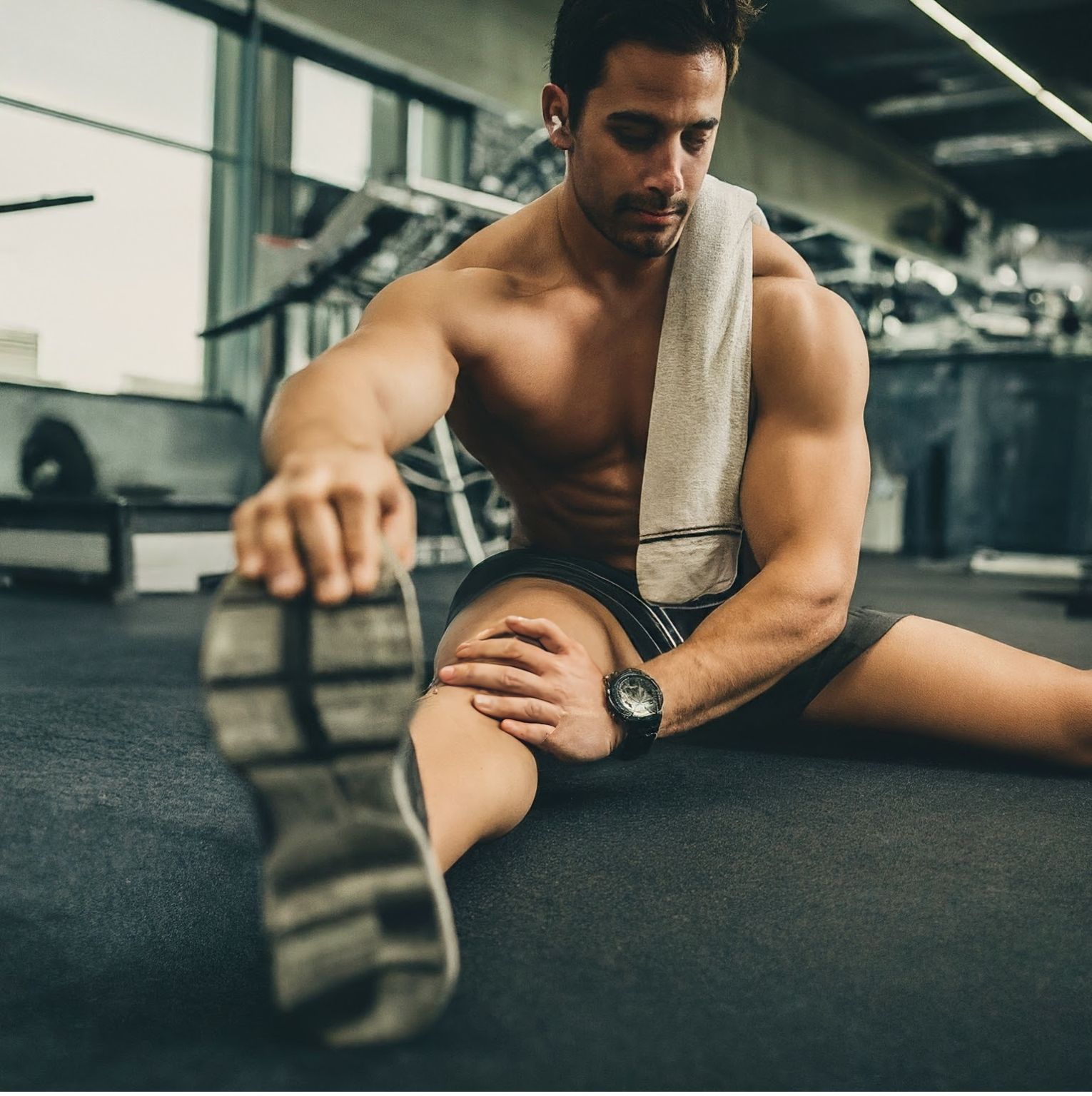 a man is stretching for post workout recovery 